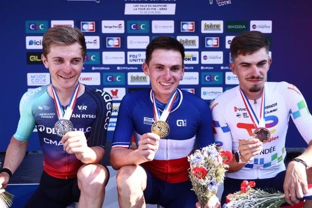 (From L) Second-placed Decathlon CMA CGM team's French rider Paul Lapeira, winner Groupama-FDJ United's French rider Romain Gregoire and third-placed TotalEnergies' French rider Joris Delbove show their medal as they celebrate on the podium after competing in the men's Elite Road Race, part of the French Cycling Championship 2026 near La Tour du Pin, central-eastern France, on June 28, 2026. (Photo by Alex MARTIN / AFP)