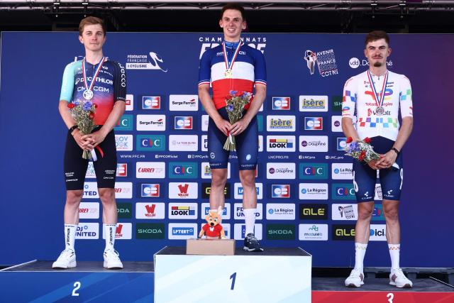 (From L) Second-placed Decathlon CMA CGM team's French rider Paul Lapeira, winner Groupama-FDJ United's French rider Romain Gregoire and TotalEnergies' French rider Joris Delbove celebrate on the podium after competing in the men's Elite Road Race, part of the French Cycling Championship 2026 near La Tour du Pin, central-eastern France, on June 28, 2026. (Photo by Alex MARTIN / AFP)