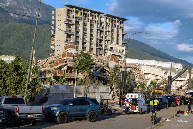 Destroyed buildings are seen in Caraballeda, La Guaira state, Venezuela, on June 28, 2026, following earthquakes. Thousands of rescuers, relatives and volunteers dig day and night through mounds of concrete to find survivors of the earthquakes that struck Venezuela more than three days ago, leaving nearly 1,500 dead and tens of thousands missing. (Photo by Miguel MEDINA / POOL / AFP)