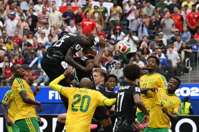 Canada's defender #15 Moise Bombito (2nd-L) heads the ball and misses a chance during the 2026 World Cup round of 32 football match between South Africa and Canada at the Los Angeles Stadium in Inglewood on June 28, 2026.  (Photo by Patrick T. Fallon / AFP)