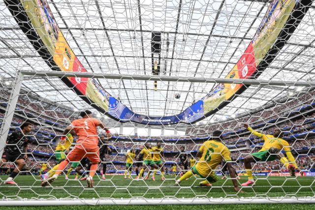 South Africa's defender #06 Aubrey Modiba clears the ball after a heading by Canada's defender #15 Moise Bombito during the 2026 World Cup round of 32 football match between South Africa and Canada at the Los Angeles Stadium in Inglewood on June 28, 2026.  (Photo by Patrick T. Fallon / AFP)