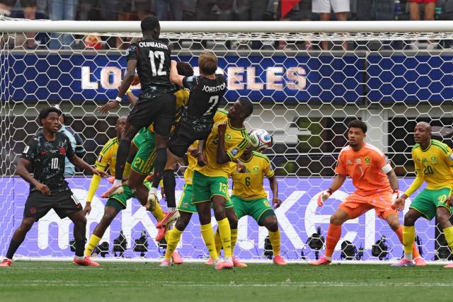 Canada's forward #12 Tani Oluwaseyi, South Africa's defender #21 Ime Okon, Canada's defender #02 Alistair Johnston, and South Africa's midfielder #13 Sphephelo Sithole fight for the ball during the 2026 World Cup round of 32 football match between South Africa and Canada at the Los Angeles Stadium in Inglewood on June 28, 2026.  (Photo by ETIENNE LAURENT / AFP)