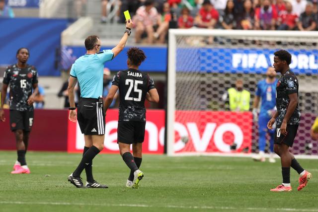 Portuguese referee Joao Pinheiro shows a yellow card to Canada's midfielder #25 Nathan Saliba during the 2026 World Cup round of 32 football match between South Africa and Canada at the Los Angeles Stadium in Inglewood on June 28, 2026.  (Photo by ETIENNE LAURENT / AFP)