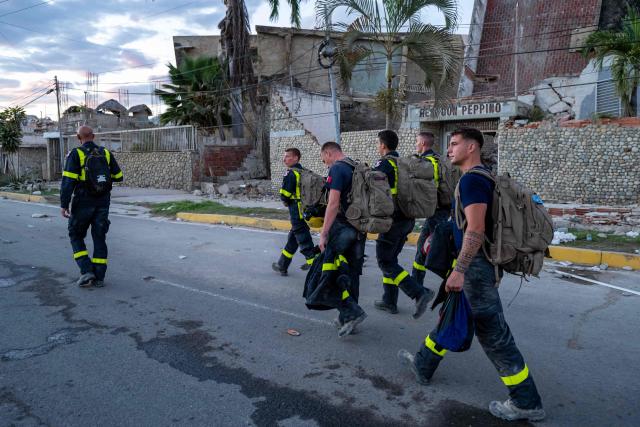Members of the French Civil Security Training and Intervention Regiment (UIISC 7) walk along a street in La Guaira state, Venezuela, on June 28, 2026, following earthquakes. Thousands of rescuers, relatives and volunteers dig day and night through mounds of concrete to find survivors of the earthquakes that struck Venezuela more than three days ago, leaving nearly 1,500 dead and tens of thousands missing. (Photo by Miguel MEDINA / POOL / AFP)