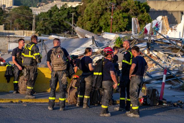 Members of the French Civil Security Training and Intervention Regiment (UIISC 7) attend an area affected by building collapses in La Guaira state, Venezuela, on June 28, 2026, following earthquakes. Thousands of rescuers, relatives and volunteers dig day and night through mounds of concrete to find survivors of the earthquakes that struck Venezuela more than three days ago, leaving nearly 1,500 dead and tens of thousands missing. (Photo by Miguel MEDINA / POOL / AFP)
