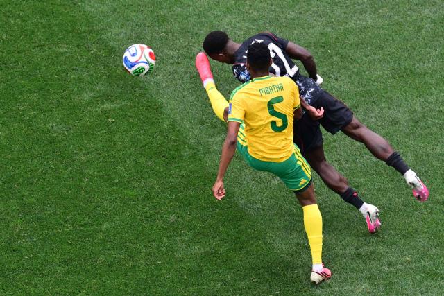 South Africa's midfielder #05 Thalente Mbatha and Canada's defender #22 Richie Laryea fight for the ball during the 2026 World Cup round of 32 football match between South Africa and Canada at the Los Angeles Stadium in Inglewood on June 28, 2026.  (Photo by Frederic J. Brown / AFP)