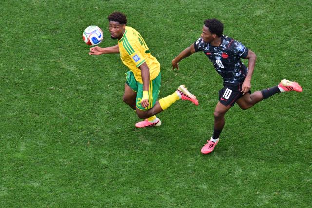 South Africa's defender #02 Thabang Matuludi and Canada's forward #10 Jonathan David fight for the ball during the 2026 World Cup round of 32 football match between South Africa and Canada at the Los Angeles Stadium in Inglewood on June 28, 2026.  (Photo by Frederic J. Brown / AFP)