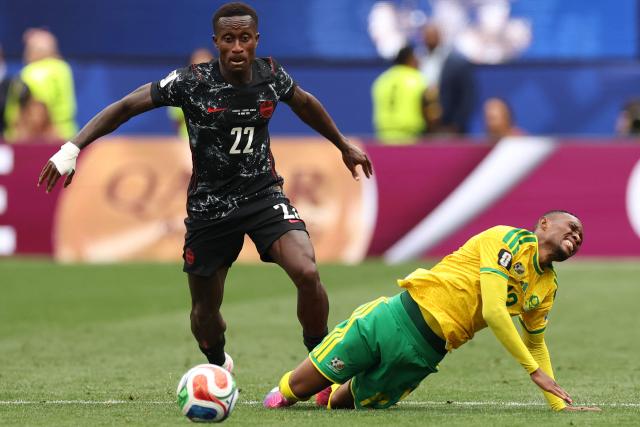 South Africa's forward #12 Thapelo Maseko (R) falls on the ground past Canada's defender #22 Richie Laryea during the 2026 World Cup round of 32 football match between South Africa and Canada at the Los Angeles Stadium in Inglewood on June 28, 2026.  (Photo by ETIENNE LAURENT / AFP)