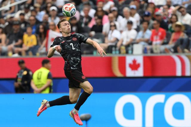 Canada's defender #02 Alistair Johnston heads the ball during the 2026 World Cup round of 32 football match between South Africa and Canada at the Los Angeles Stadium in Inglewood on June 28, 2026.  (Photo by Patrick T. Fallon / AFP)