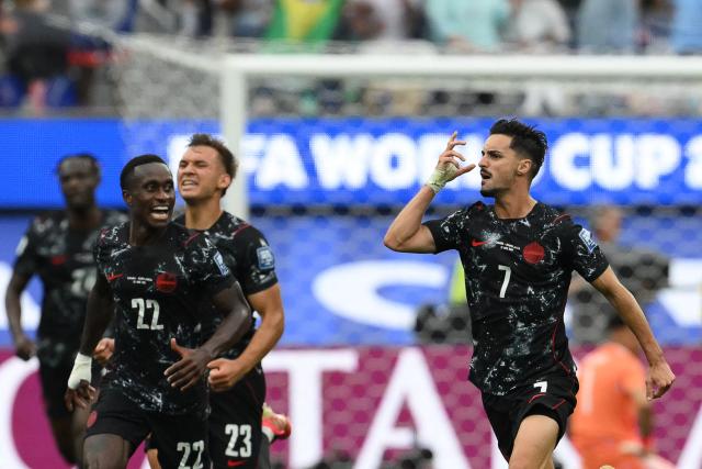 Canada's midfielder #07 Stephen Eustaquio (R) celebrates scoring his team's first goal during the 2026 World Cup round of 32 football match between South Africa and Canada at the Los Angeles Stadium in Inglewood on June 28, 2026.  (Photo by Patrick T. Fallon / AFP)