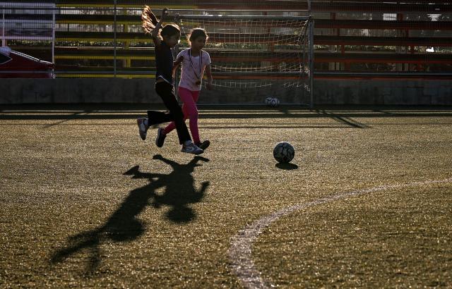 Palestinian girls play football in Turmus Ayya, northeast of Ramallah, with the Israeli settlement of Shilo visible in the background, amid escalating settler attacks and Israeli movement restrictions limiting access to public spaces and disrupting daily life, on June 28, 2026. Violence has escalated in the West Bank, which Israel has occupied since 1967, since the start of the Gaza war in October 2023. (Photo by Zain JAAFAR / AFP)