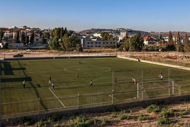 Palestinian girls play football in Turmus Ayya, northeast of Ramallah, with the Israeli settlement of Shilo visible in the background, amid escalating settler attacks and Israeli movement restrictions limiting access to public spaces and disrupting daily life, on June 28, 2026. Violence has escalated in the West Bank, which Israel has occupied since 1967, since the start of the Gaza war in October 2023. (Photo by Zain JAAFAR / AFP)