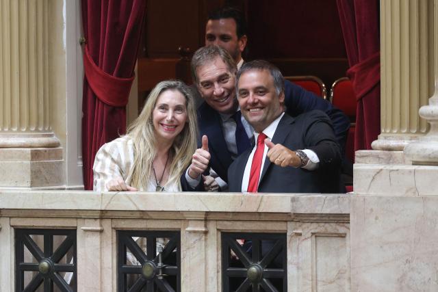 (FILES) Argentina's Secretary General of the Presidency Karina Milei (L), Interior Minister Diego Santilli (C), and Chief of Cabinet and government spokesman Manuel Adorni (R) pose for a photo as they arrive at the chamber of deputies during a session to debate labor law reforms at the National Congress in Buenos Aires, early on February 20, 2026. Argentina's President Javier Milei on June 28, 2026 appointed Diego Santilli, who had been serving as Interior Minister, as the new Chief of Staff, replacing Manuel Adorni, who resigned on the eve amid a judicial investigation for alleged illicit enrichment. (Photo by Tomas CUESTA / AFP)