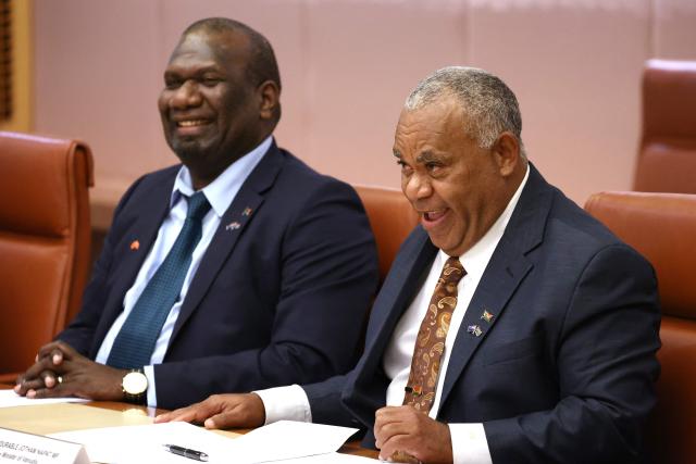 Vanuatu's Prime Minister Jotham Napat (R) and Foreign Minister Marc Ati attend a meeting with Australian Prime Minister Anthony Albanese and cabinet members at Parliament House in Canberra on June 29, 2026. (Photo by David GRAY / AFP)