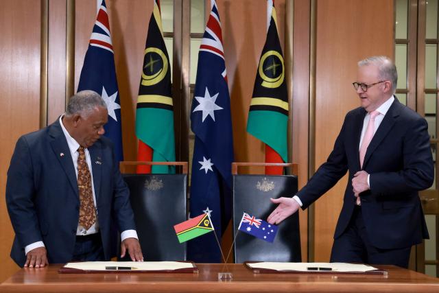 Australian Prime Minister Anthony Albanese (R) and Vanuatu's Prime Minister Jotham Napat prepare to sign The Nakamal Agreement during a signing ceremony at Parliament House in Canberra on June 29, 2026. (Photo by DAVID GRAY / AFP)