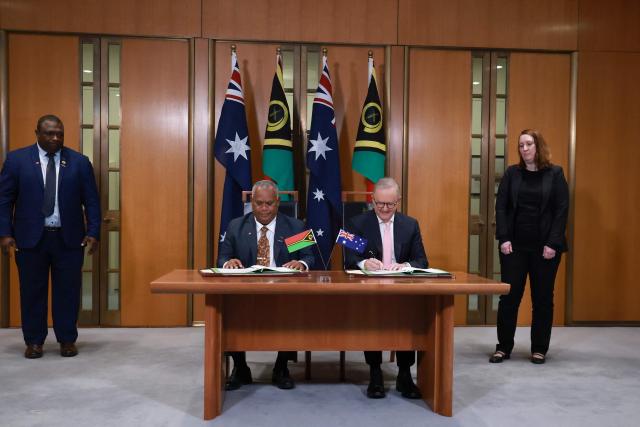 Australian Prime Minister Anthony Albanese (2nd R) and Vanuatu's Prime Minister Jotham Napat (2nd L) sign The Nakamal Agreement during a signing ceremony at Parliament House in Canberra on June 29, 2026. (Photo by DAVID GRAY / AFP)