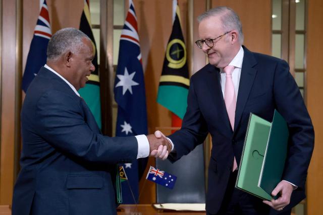 Australian Prime Minister Anthony Albanese (R) and Vanuatu's Prime Minister Jotham Napat shake hands after signing The Nakamal Agreement during a signing ceremony at Parliament House in Canberra on June 29, 2026. (Photo by DAVID GRAY / AFP)