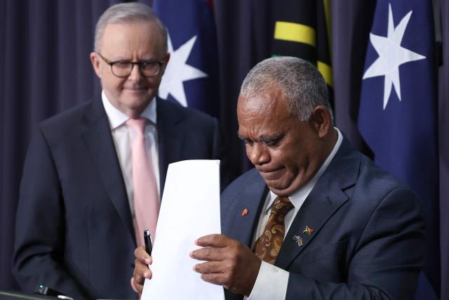 Vanuatu's Prime Minister Jotham Napat (R) arranges documents following a joint press conference with Australian Prime Minister Anthony Albanese at Parliament House in Canberra on June 29, 2026. (Photo by David GRAY / AFP)