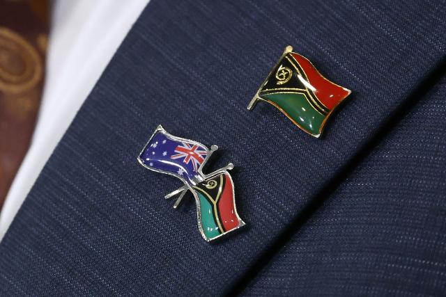 National flag pins of Australia and Vanuatu are seen on the coat of Vanuatu's Prime Minister Jotham Napat during a joint press conference with Australian Prime Minister Anthony Albanese at Parliament House in Canberra on June 29, 2026. (Photo by David GRAY / AFP)