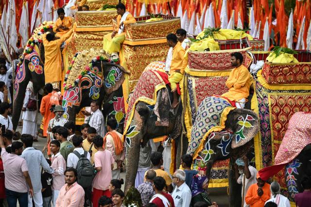 Mahouts wait with decorated elephants during Jal Yatra, a Hindu religious procession from Lord Jagannath temple to Sabarmati riverfront in Ahmedabad on June 29, 2026. (Photo by Shammi MEHRA / AFP)