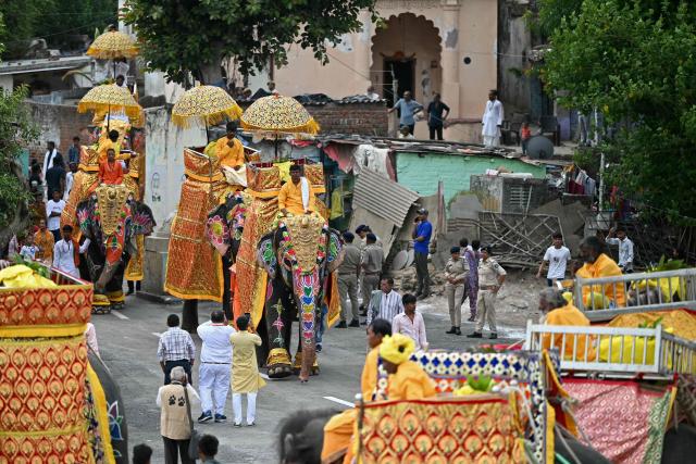 Mahouts ride decorated elephants during Jal Yatra, a Hindu religious procession from Lord Jagannath temple to Sabarmati riverfront in Ahmedabad on June 29, 2026. (Photo by Shammi MEHRA / AFP)