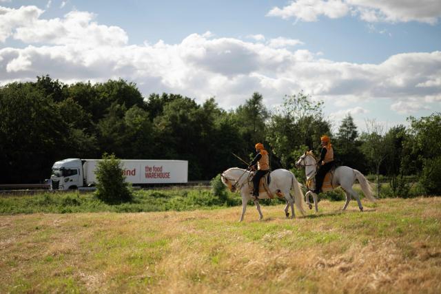 Riders prepare to compete at the Bury Championship Neza Bazi event adjacent to the M66 motorway in Unsworth, near Bury, northern England on June 28, 2026. Neza Bazi, also known as tent pegging, sees riders on horseback use a lance or sword to strike and pick up small targets from the ground whilst at full gallop. The sport is believed to have originated in the Indian subcontinent during the Middle Ages. It is one of only ten equestrian sports officially recognised by the International Equestrian Federation. (Photo by Oli SCARFF / AFP)