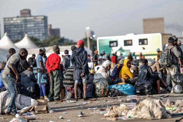Undocumented migrants queue to board the last buses leaving the Durban Drive In in central Durban, on June 29, 2026. South Africans President Cyril Ramaphosa vowed on June 25 to crush any attempts to destabilise the nation during planned anti-immigrant marches next week, amid a wave of xenophobia. Citizen-led groups have set Tuesday 30 as a deadline for undocumented foreigners to leave and called for nationwide marches against illegal immigration, marking a crescendo in months of protests that have at times turned violent. (Photo by Marco Longari / AFP)