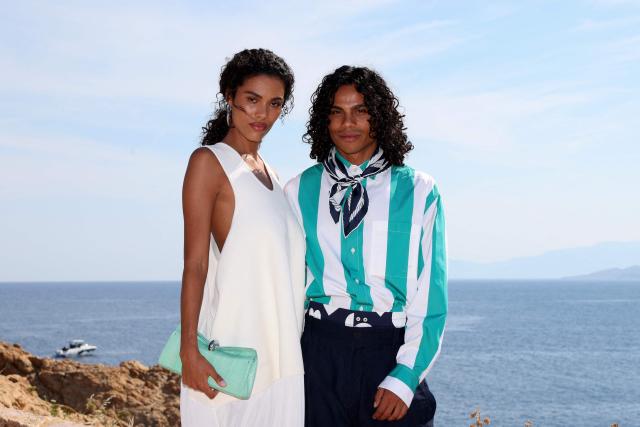 French model Tina Kunakey (L) and her brother Zakari Kunakey pose for a photocall upon arrival to attend the Jacquemus "Le Bohneur" collection fashion show in L'Ile-Rousse on the French Mediterranean island of Corsica on June 29, 2026. (Photo by Pascal POCHARD-CASABIANCA / AFP)