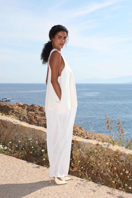 French model Tina Kunakey poses for a photocall upon arrival to attend the Jacquemus "Le Bohneur" collection fashion show in L'Ile-Rousse on the French Mediterranean island of Corsica on June 29, 2026. (Photo by Pascal POCHARD-CASABIANCA / AFP)