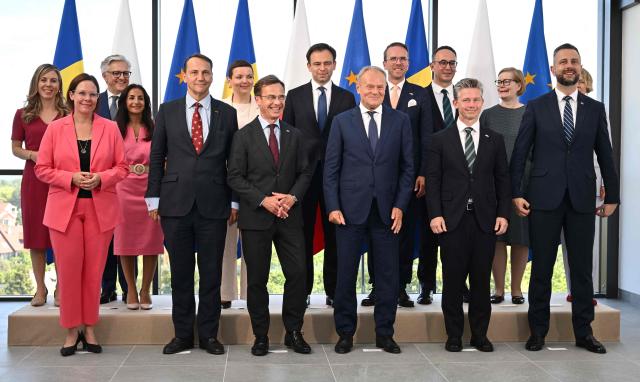 Polish Prime Minister Donald Tusk (C-R) and Sweden's Prime Minister Ulf Kristersson (C-L) pose for a group photo with members of their delegations during a meeting in Gdynia, Poland on June 29, 2026. Sweden's Prime Minister Ulf Kristersson and several of his ministers travelled to Gdynia, Poland for intergovernmental consultations. The focus will be on strengthened bilateral cooperation between Sweden and Poland, specifically with regard to regional security and defence. (Photo by Marcin Gadomski / AFP)