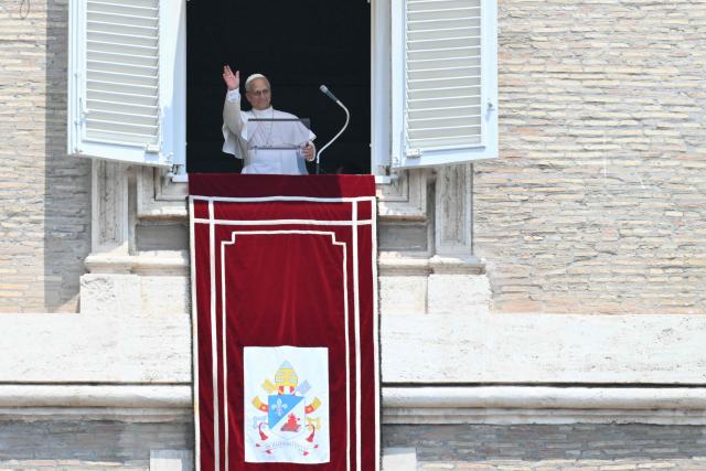 Pope Leo XIV waves to the crowd from the window of the apostolic palace overlooking St. Peter's square during the Regina Caeli prayer in The Vatican on June 29, 2026. (Photo by Alberto PIZZOLI / AFP)