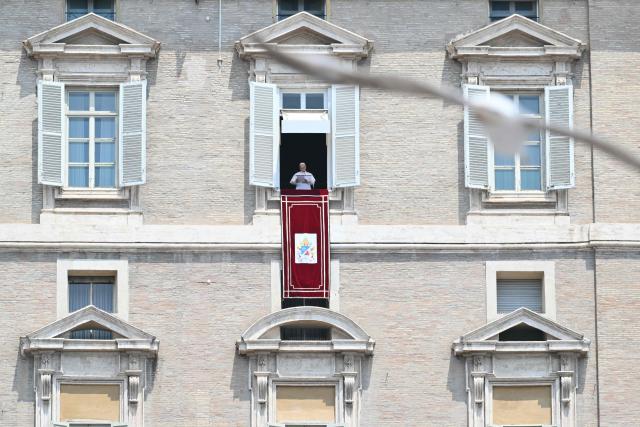 Pope Leo XIV addresses the crowd from the window of the apostolic palace overlooking St. Peter's square during the Regina Caeli prayer in The Vatican on June 29, 2026. (Photo by Alberto PIZZOLI / AFP)