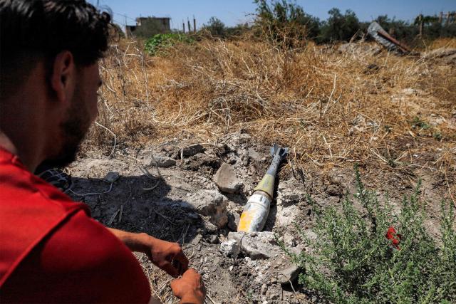 A man looks at an unexploded artillery shell that fell during reported overnight Israeli bombardment that hit the village of Abidin in Syria's southwestern Daraa province, close to the Golan Heights, on June 29, 2026. Syria's foreign ministry condemned on June 29 Israeli incursions and shelling in the south of the country, a day after an escalation in the village in Daraa province forced its residents to temporarily flee, according to local officials. (Photo by Sam HARIRI / AFP)