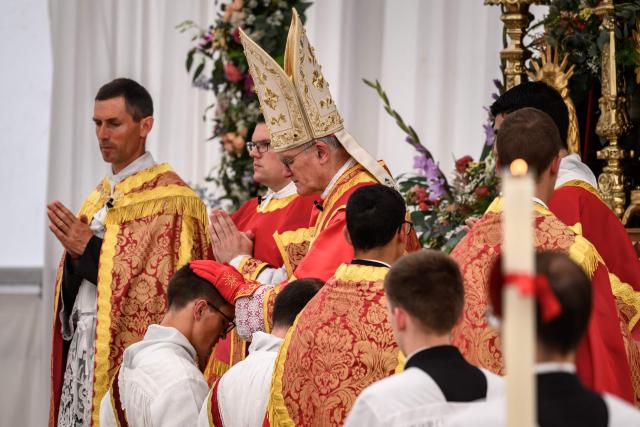 A new priest receives the laying on of hands by Swiss traditionalist Catholic Bishop and former Superior General of the Society of Saint Pius X (SSPX) Bernard Fellay, during an ordination ceremony of the traditionalist Catholic Society of Saint Pius X (SSPX), in Econe, near Sion, western Switzerland, on June 29, 2026. Defying Vatican, Society of Saint Pius X will ordain its own bishops on July 1, 2026, despite the risk of being considered schismatic. (Photo by Fabrice COFFRINI / AFP)