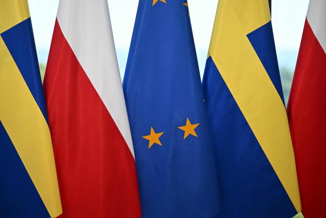 Sweden's and Poland's national flags are seen beside the EU flag (C) during the visit of Sweden's Prime Minister on June 29, 2026 in Gdynia, Poland. Sweden's Prime Minister Ulf Kristersson and several of his ministers travelled to Gdynia, Poland for intergovernmental consultations. The focus will be on strengthened bilateral cooperation between Sweden and Poland, specifically with regard to regional security and defence. (Photo by Marcin Gadomski / AFP)