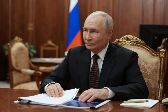 In this pool photograph distributed by the Russian state agency Sputnik, Russia's President Vladimir Putin attends a meeting with the country's human rights commissioner at the Kremlin in Moscow on June 29, 2026. (Photo by Gavriil Grigorov / POOL / AFP)