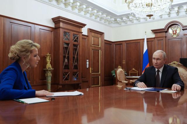 In this pool photograph distributed by the Russian state agency Sputnik, Russia's President Vladimir Putin meets with the country's human rights commissioner Yana Lantratova at the Kremlin in Moscow on June 29, 2026. (Photo by Gavriil Grigorov / POOL / AFP)