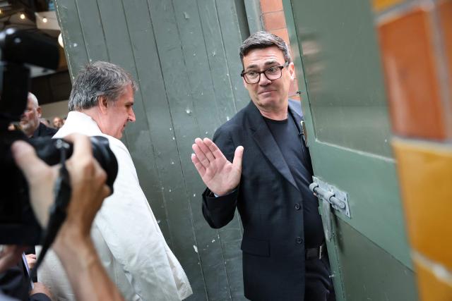 Labour MP and challenger for Leader of the Labour party, Andy Burnham, (R) waves as he leaves with Mayor of the Liverpool City Region Steve Rotherham, after delivering a speech in Manchester, northern England, on June 29, 2026. Burnham, the frontrunner to become Britain's next prime minister, set out his economic agenda on Monday, in his first major policy announcement since Keir Starmer resigned as premier last week. (Photo by Toby Shepheard / AFP)