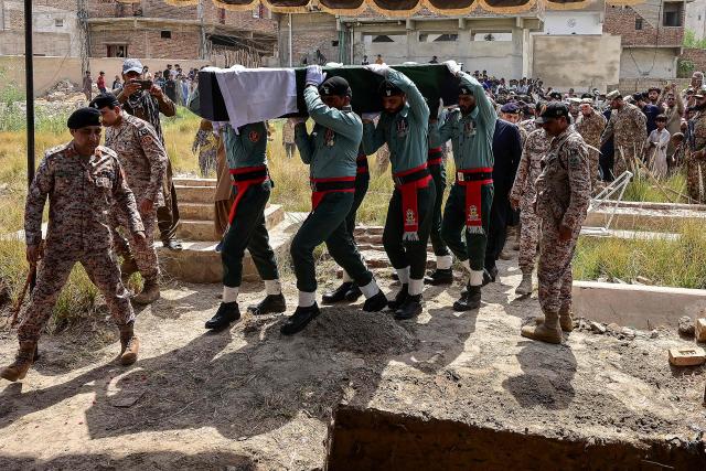 Pakistani Rangers carry the coffin of a paramilitary soldier killed in a terror attack during his funeral in Hyderabad, Sindh province, on June 29, 2026. Three Pakistani Rangers were killed in a terror attack in the southern megacity Karachi on June 27 evening, the country's military said, following an explosion and heavy gunfire. (Photo by Akram SHAHID / AFP)