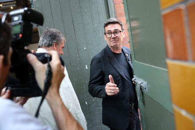Labour MP and challenger for Leader of the Labour party, Andy Burnham, (R) makes a 'thumbs up' gesture as he leaves with Mayor of the Liverpool City Region Steve Rotherham, after delivering a speech in Manchester, northern England, on June 29, 2026. Burnham, the frontrunner to become Britain's next prime minister, set out his economic agenda on Monday, in his first major policy announcement since Keir Starmer resigned as premier last week. (Photo by Toby Shepheard / AFP)