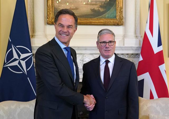 Britain's Prime Minister Keir Starmer (R) shakes hands with NATO Secretary General Mark Rutte during their meeting inside 10 Downing Street in central London on June 29, 2026. (Photo by Alberto Pezzali / POOL / AFP)