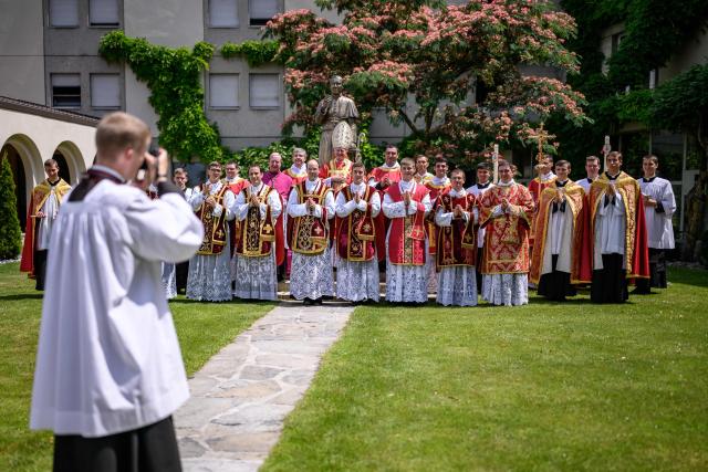 Priests and deacons pose next to a statue of Saint Pius X after an ordination ceremony of the traditionalist Catholic Society of Saint Pius X (SSPX), in Econe, near Sion, western Switzerland, on June 29, 2026. Defying Vatican, Society of Saint Pius X will ordain its own bishops on July 1, 2026, despite the risk of being considered schismatic. (Photo by Fabrice COFFRINI / AFP)