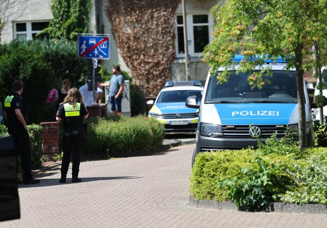 Police stand near the scene where five people were killed in a shooting in Stade, northern Germany, a city some 50 kilometres west of Hamburg, on June 29, 2026. German police said five people were killed and others injured on June 29, 2026 in a shooting in a youth welfare facility in the northern city of Stade. Two people were arrested, including the suspected shooter, and there was now "no danger to the public", local police said in an update around 1215 GMT. (Photo by Ibrahim OT / AFP)