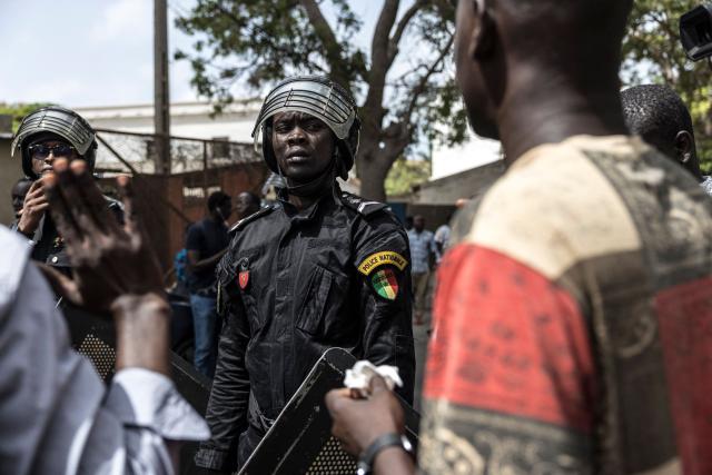 A Senegalese police officer wearing riot gear looks at a protester during a demonstration against a constitutional reform bill near the National Assembly in Dakar, on June 29, 2026. Senegal’s National Assembly was examining, in a tense atmosphere marked by heated exchanges between lawmakers and clashes between demonstrators and police outside the building, a bill revising the Constitution concerning the powers of the President, Parliament, and the Prime Minister. The initiative, put forward by the parliamentary majority and its leader Ousmane Sonko, comes amid a deep disagreement with the country’s president. (Photo by PATRICK MEINHARDT / AFP)