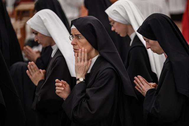 Nuns wait before receiving Communion during an ordination ceremony of the traditionalist Catholic Society of Saint Pius X (SSPX), in Econe, near Sion, western Switzerland, on June 29, 2026. Defying Vatican, Society of Saint Pius X will ordain its own bishops on July 1, 2026, despite risk of being considered schismatic. (Photo by Fabrice COFFRINI / AFP)