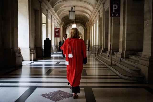 A judge walks through a hallway at the Paris Courthouse, in Paris on June 29, 2026. (Photo by SIMON WOHLFAHRT / AFP)