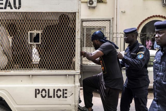 Senegalese police officers arrest a protester during a demonstration against a constitutional reform bill near the National Assembly in Dakar, on June 29, 2026. Senegal’s National Assembly was examining, in a tense atmosphere marked by heated exchanges between lawmakers and clashes between demonstrators and police outside the building, a bill revising the Constitution concerning the powers of the President, Parliament, and the Prime Minister. The initiative, put forward by the parliamentary majority and its leader Ousmane Sonko, comes amid a deep disagreement with the country’s president. (Photo by PATRICK MEINHARDT / AFP)