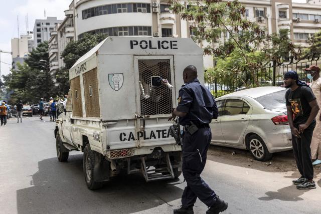 A Senegalese police officer inside a vehicle hands a teargas canister to another police officer during a demonstration against a constitutional reform bill near the National Assembly in Dakar, on June 29, 2026. Senegal’s National Assembly was examining, in a tense atmosphere marked by heated exchanges between lawmakers and clashes between demonstrators and police outside the building, a bill revising the Constitution concerning the powers of the President, Parliament, and the Prime Minister. The initiative, put forward by the parliamentary majority and its leader Ousmane Sonko, comes amid a deep disagreement with the country’s president. (Photo by PATRICK MEINHARDT / AFP)