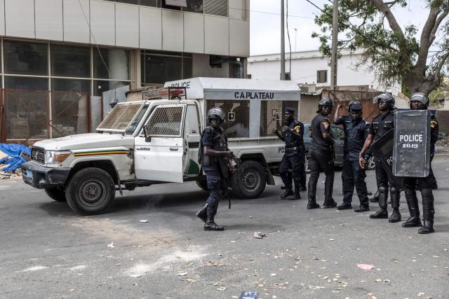 Senegalese police officers stand in formation after dispersing protesters during a demonstration against a constitutional reform bill near the National Assembly in Dakar, on June 29, 2026. Senegal’s National Assembly was examining, in a tense atmosphere marked by heated exchanges between lawmakers and clashes between demonstrators and police outside the building, a bill revising the Constitution concerning the powers of the President, Parliament, and the Prime Minister. The initiative, put forward by the parliamentary majority and its leader Ousmane Sonko, comes amid a deep disagreement with the country’s president. (Photo by PATRICK MEINHARDT / AFP)