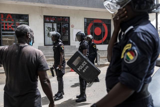 Senegalese police officers wearing riot gear look at protesters during a demonstration against a constitutional reform bill near the National Assembly in Dakar, on June 29, 2026. Senegal’s National Assembly was examining, in a tense atmosphere marked by heated exchanges between lawmakers and clashes between demonstrators and police outside the building, a bill revising the Constitution concerning the powers of the President, Parliament, and the Prime Minister. The initiative, put forward by the parliamentary majority and its leader Ousmane Sonko, comes amid a deep disagreement with the country’s president. (Photo by PATRICK MEINHARDT / AFP)